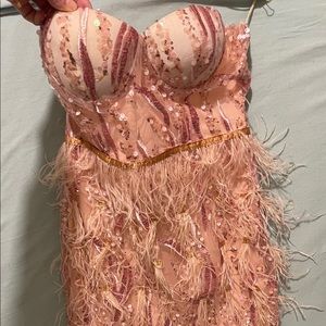 Baby pink mini dress with feather embellishment and sequin detail